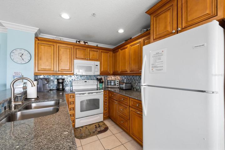 Wood cabinets and coastal tile backsplash