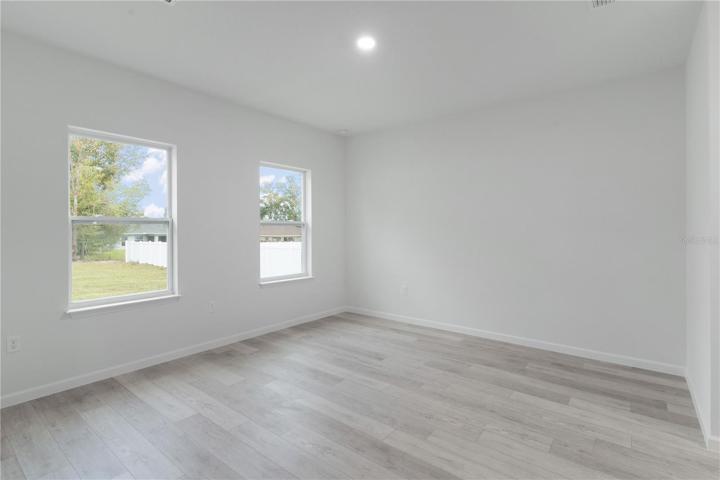 Primary bedroom has 2 large windows providing lots of natural light