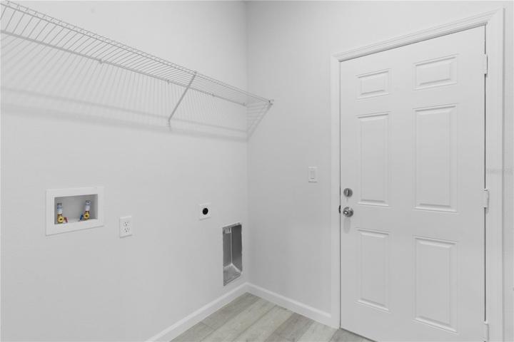 Inside laundry off of the kitchen, with a door leading to the garage