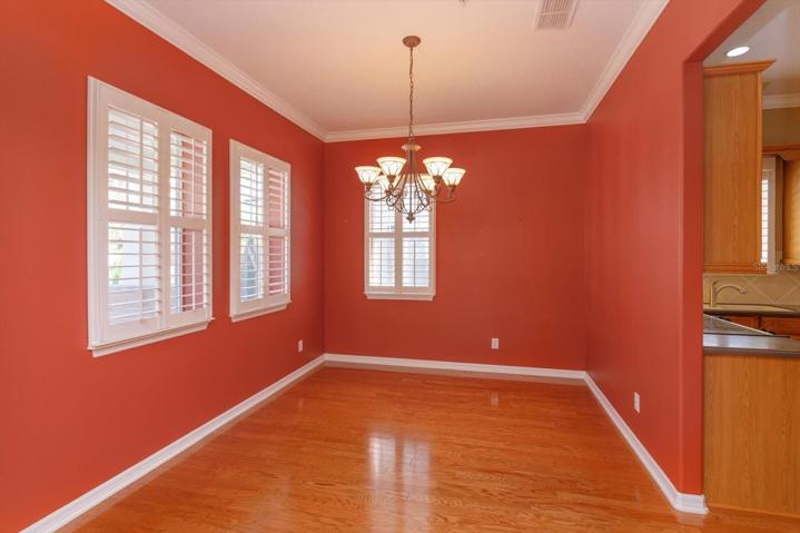 Formal Dining Room . Wood floors and plantation shutters throughout.