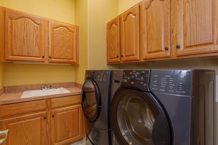 Laundry room with lots of storage, comes with washer and dryer and has a soaking tub.