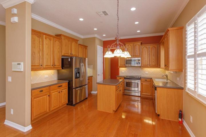 Kitchen with stainless appliances, wood cabinetry, and a prep island.  Ready to entertain your friends and family.