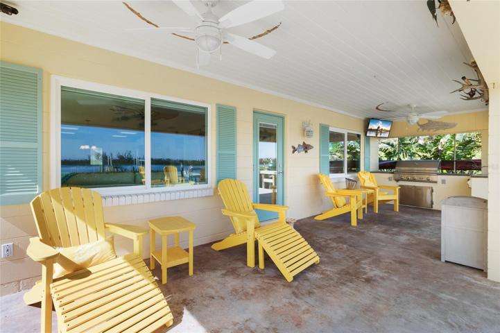 Front porch includes a grill area, TV, and plenty of seating!