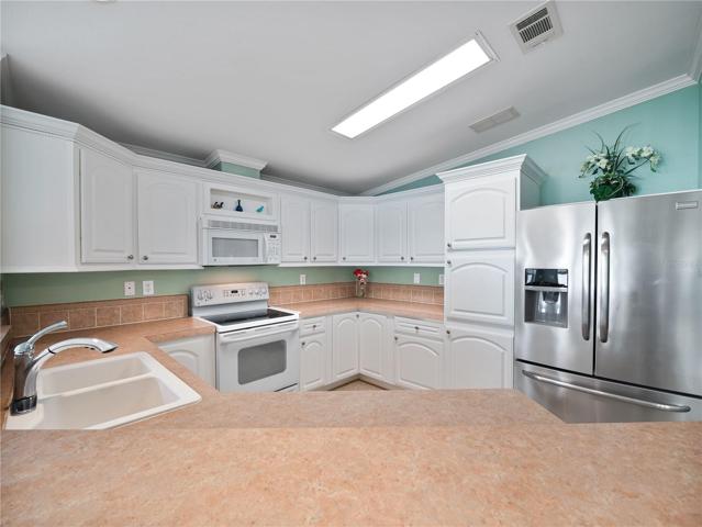 The kitchen has tons of cabinets and counter space, and comes with all the appliances.