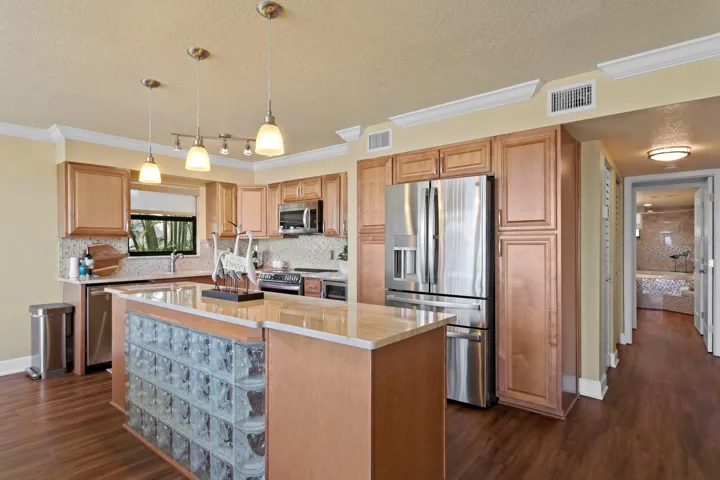 Stone counter tops and updated backsplash, newer LVP flooring, and glass block island front, are waiting for you.