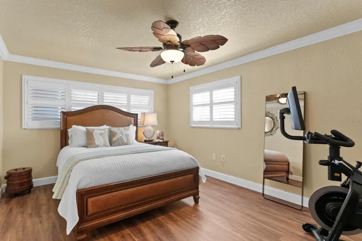 Bedroom #2 with Plantation Shutters, Crown Molding, newer flooring, and oversized.
