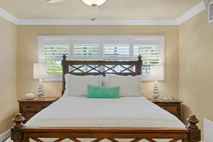 Primary Bedroom with two new windows, plantation shutters, and crown molding.
