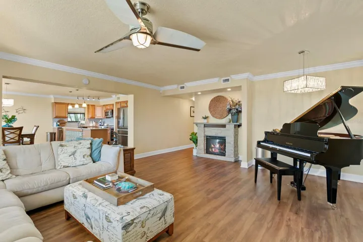 Open great room design with additional windows on the side and front of the room.