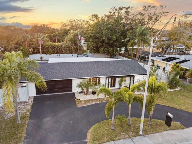 Front aerial of the property showing the circular driveway, two car garage, and new roof