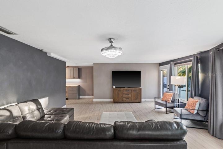 Living Room featuring impact windows, a nook perfect for a home office or library, and views of your backyard.