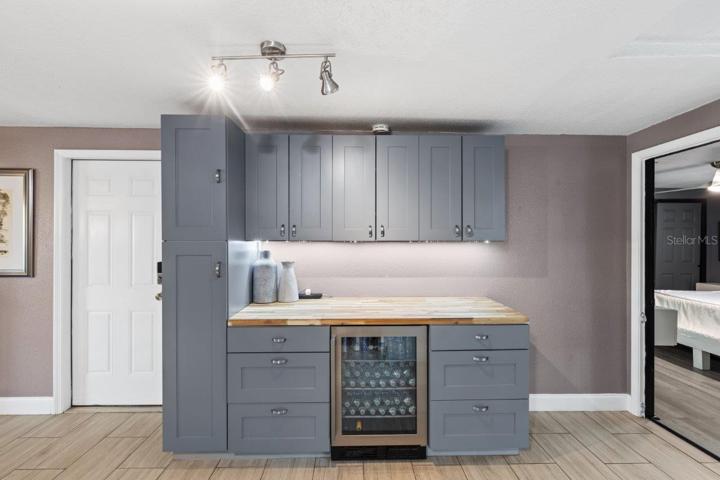 Coffee Bar featuring a Chopping Block counter top, and a wine fridge.