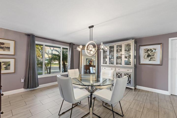 Dining Room featuring wood-look tile flooring, and stunning fixtures