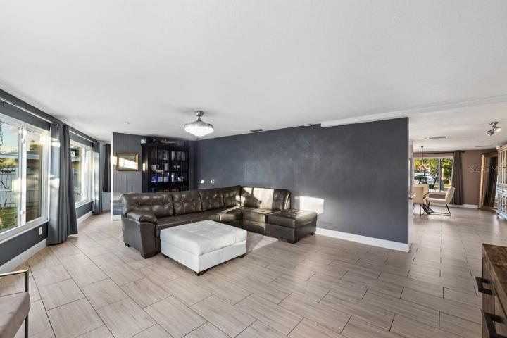 Living Room featuring impact windows, a nook perfect for a home office or library, and views of your backyard.