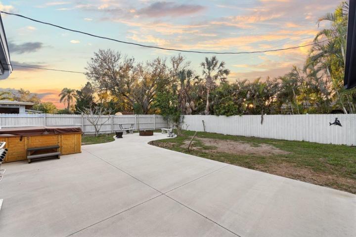 Spacious fenced-in back yard featuring a newly built concrete patio, gazebo, and firepit!