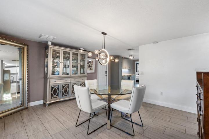 Dining Room featuring wood-look tile flooring, and stunning fixtures