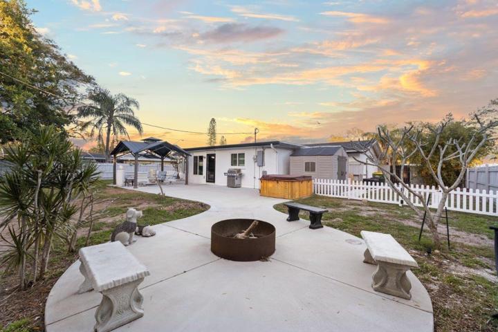Spacious fenced-in back yard featuring a newly built concrete patio, gazebo, and firepit!