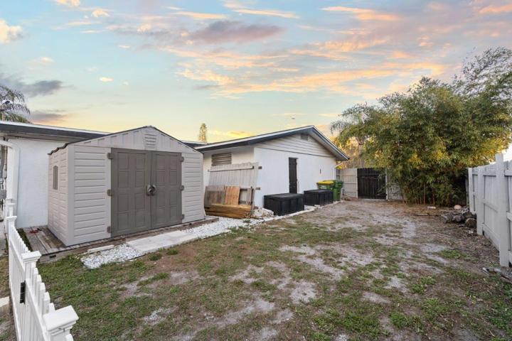 Spacious fenced-in back yard featuring a newly built concrete patio, gazebo, and firepit!