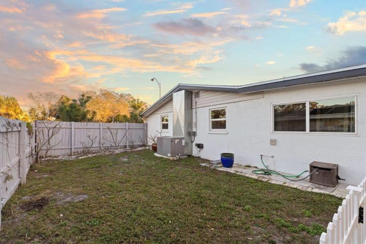 Spacious fenced-in back yard featuring a newly built concrete patio, gazebo, and firepit!