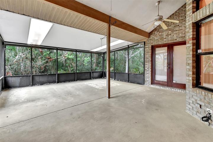 Screened room with french doors leading to master bedroom and sliding doors to living room.