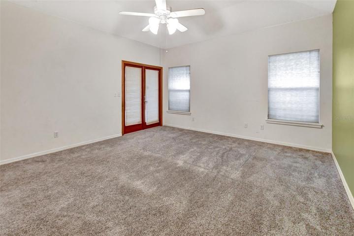 Master bedroom with french doors leading out to screened porch area.