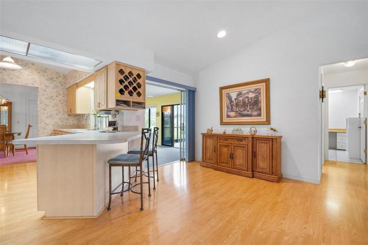 The enclosed lanai is located off the kitchen and family room.