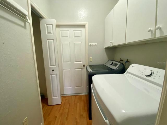 Laundry room with closet for extra storage