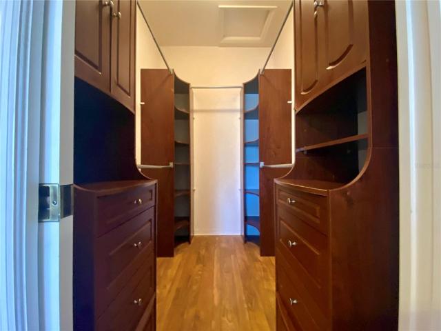 Custom closet with cabinets and shelves