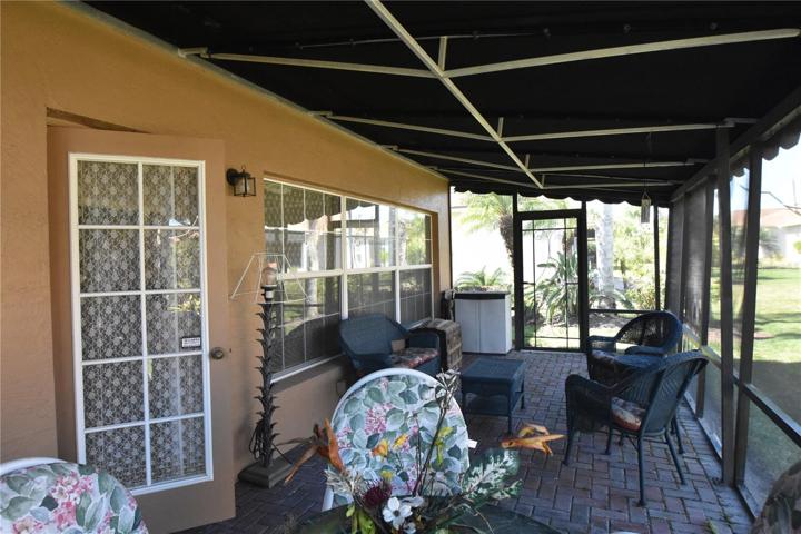 Door entry into the enclosed lanai from the large screened in covered lanai.