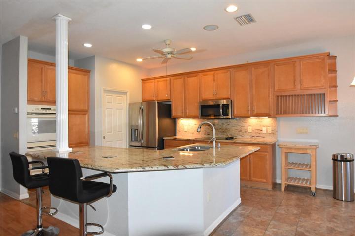 Kitchen with large island featuring granite countertops