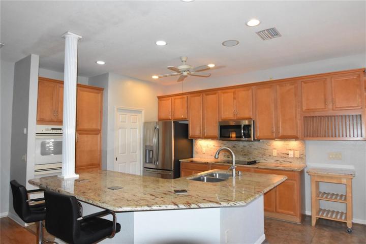 Stainless steel appliances along with double ovens and pantry cabinet