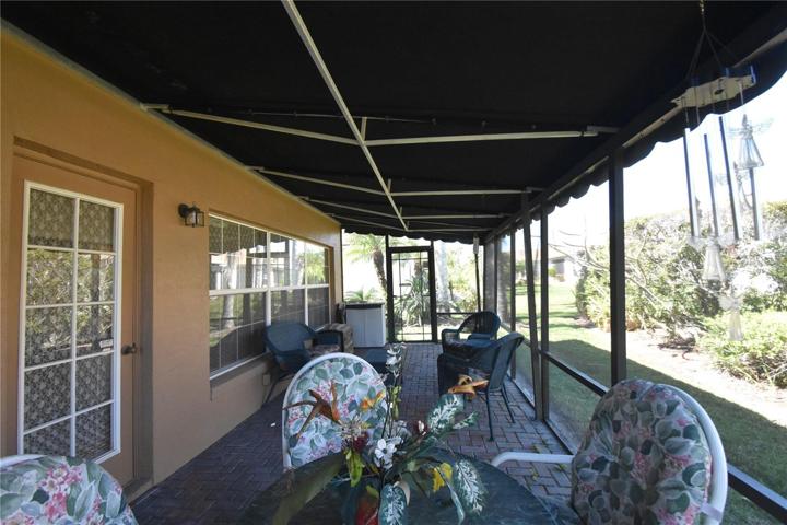 Screened in lanai with covered roof and doors at each end to exit out to backyard.