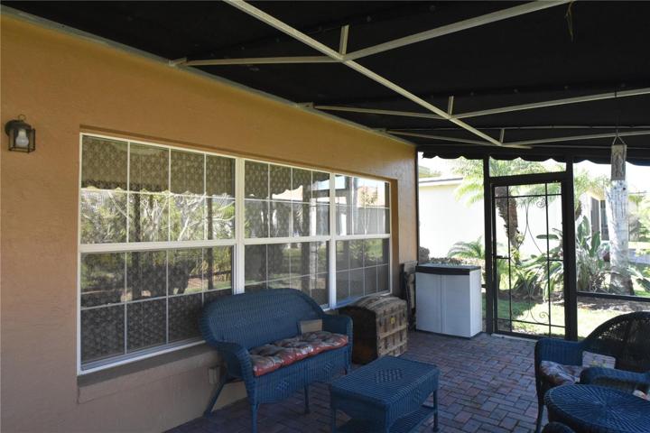 Large windows bringing in lots of natural light to the enclosed dining room