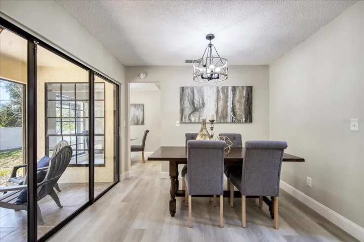 Triple sliding doors open to screened lanai~