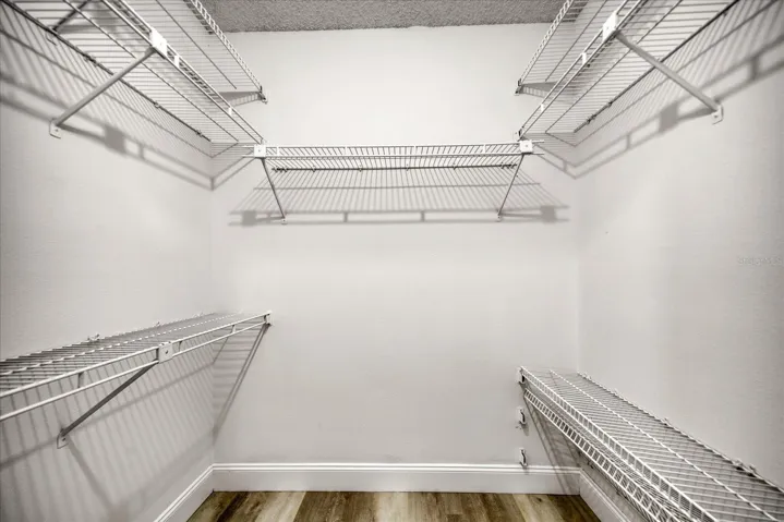 Nicely outfitted walk in closet. Flooring is the same; just different light~