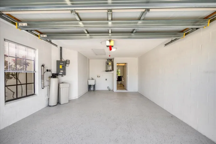 Freshly painted garage with new floor finish. Convenient laundry station & utility sink~