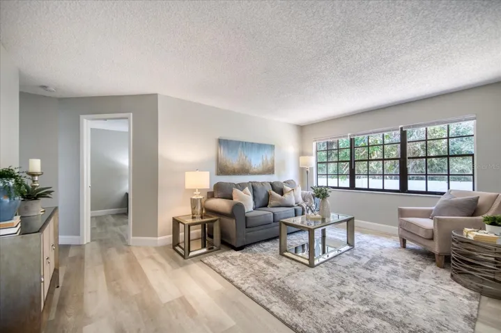 Great living room windows & privacy wall with lush green view in back~
