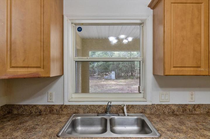 Kitchen sink with view to lanai and back yard