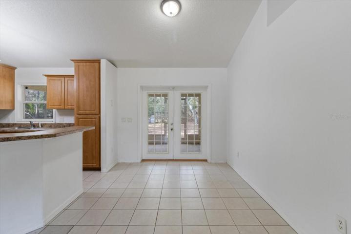 Eat-in kitchen area with french doors to screened lanai