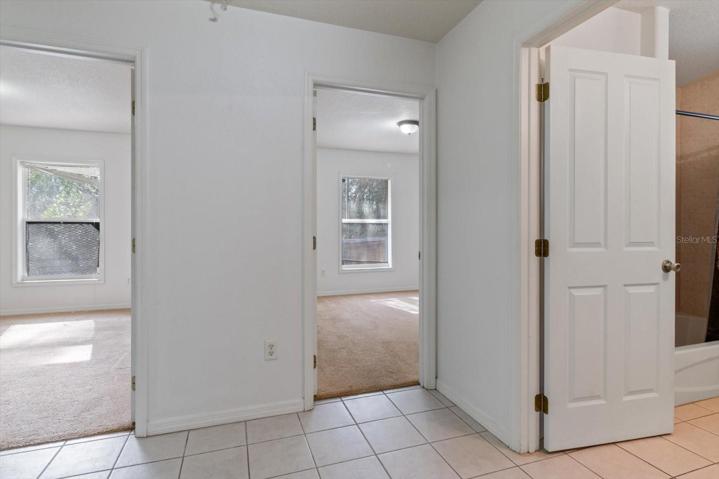 Bedrooms 2 and 3 with guest/2nd bath on right