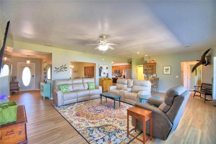 LIVING AREA OPEN TO FOYER, DINING RM, & KITCHEN
