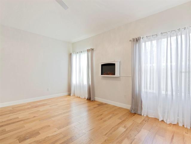 Primary Bedroom with wall mounted electric fireplace