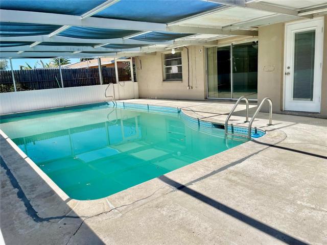 Living room opens up to in-ground Gunite Pool