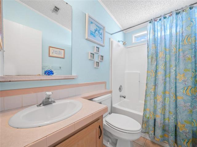 The guest bathroom has a tub and shower.