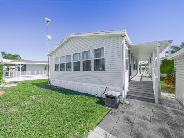There is a long covered walkway on the side of the home, with two entrance doors.
