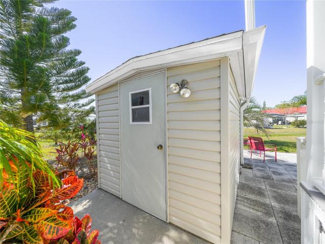 The shed has power and houses the washer and dryer, with room leftover for your tools.
