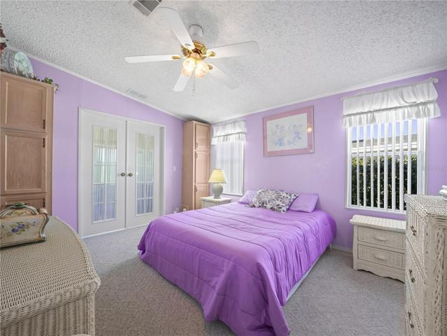 The spacious owners bedroom has French doors that lead to the family room, plus built-in cabinets.