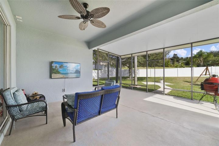 The screened lanai overlooks a FULLY FENCED BACKYARD with mature trees and landscaping, the perfect start to create the backyard of your dreams!