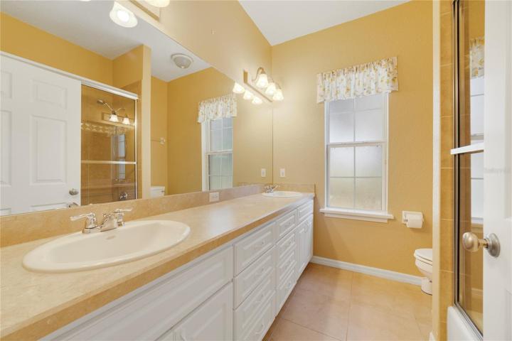 Bathroom #2 with dual sinks and tub