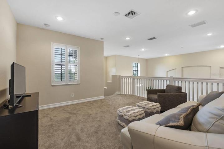 This upstairs living room loft is a great space to entertain