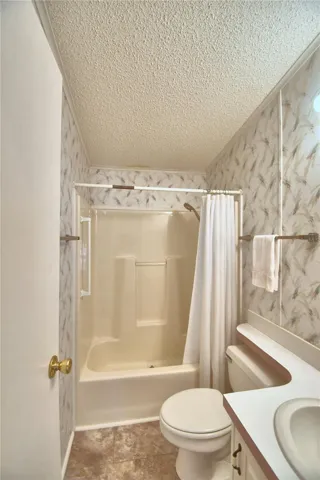 Guest bathroom has a tub and shower.